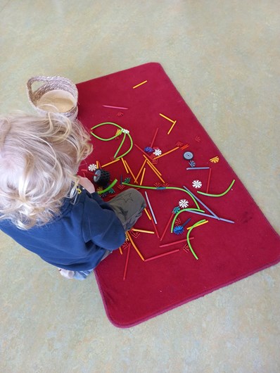 De kinderen werken niet alleen aan de tafels, maar ook op kleedjes met Montessori- en constructie materiaal.